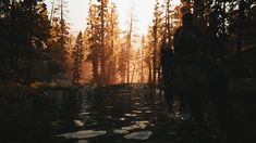 a man riding on the back of a horse through a forest