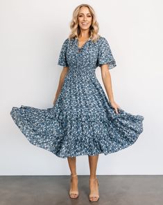 Blue-tiful blooms in this brand new pattern of the Spell Boho Midi Dress! 🌼💙 Shop this New Arrival now! 🛍️ Flowy Floral Sundress With Smocked Bodice, Flowy Floral Dress With Smocked Back And Short Sleeves, V-neck Midi Dress With Smocked Bodice For Garden Party, Flowy Floral Print Smocked Sundress, Flowy Tiered Floral Dress With Smocked Back, Flowy Ruched Floral Dress For Garden Party, Bohemian Rayon Dress With Smocked Bodice, Bohemian Flowy Floral Dress With Smocked Bodice, Casual Flowy Floral Dress With Ruched Detail