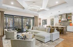 a living room filled with furniture and lots of windows