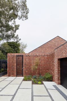 an outdoor courtyard with brick walls and plants