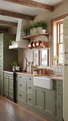 a kitchen with green cabinets and wooden floors