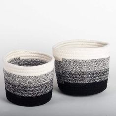 two black and white baskets sitting next to each other