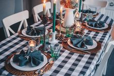 the table is set with black and white checkered cloths, candles, and plates