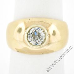 --Stone(s):-- (1) Natural Genuine Diamond - Old European Cut - Bezel Set - L/M Color - SI2 Clarity Total Carat Weight: 1.02 (exact) Material: Solid 18k Yellow Gold  Weight: 12.87 Grams Ring Size: 7.5 (Fitted on a finger. We can custom size this ring - please contact us prior to purchase for sizing inquires) Ring Width: 12.1mm (0.47") (top of the ring - north to south) - 4.3mm (bottom of the shank) Ring Height: 5.2mm rise off the finger Condition: Excellent condition! Stock Number: MK-440193534-2 Yellow Gold Wide Band Jewelry With Bezel Setting, Yellow Gold Jewelry With Bezel Setting In Wide Band, Fine Jewelry Wide Band With Single Diamond, Classic Jewelry With Bezel Setting And Wide Band, Yellow Gold Solitaire Jewelry With Wide Band, Fine Jewelry Single Diamond Wide Band, Fine Jewelry With Single Diamond Wide Band, Wide Band Solitaire Jewelry For Formal Occasions, Formal Solitaire Jewelry With Wide Band