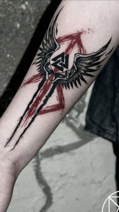 an arm with a black and red tattoo on it