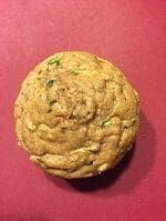 a chocolate chip cookie sitting on top of a red surface