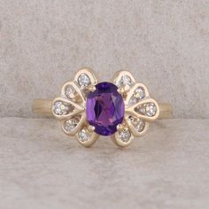 This ladies 14k yellow gold ring has one oval amethyst at the center that measures 7x5 mm. There are ten round diamonds that weigh approx 0.20cttw and are accented around the amethyst. The ring weighs 3.40 grams and the finger size is 6. It measures 10.5 mm in height and 14.4mm in length. Condition: Pre-Owned *All items are thoroughly inspected for quality assurance purposes Classic Oval Amethyst Ring With Diamond, Classic Oval Purple Birthstone Ring, Purple Oval Diamond Ring, Elegant Purple Oval Birthstone Ring, Oval Amethyst Ring With Diamond Accents For Anniversary, Oval Amethyst Ring With Accent Stones In 14k Gold, 14k Gold Oval Amethyst Ring With Accent Stones, Oval Purple Diamond Ring With Gemstone Accents, Oval Amethyst Ring With Accent Stones In Yellow Gold