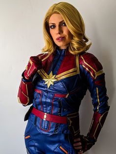 a woman dressed as captain america posing for the camera with her hands on her hips