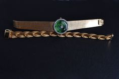 "Fine watch bracelet set with a jade donut and accented with diamonds in 18k. The donut is a deep green Omphacite jade, in parts dark and light like a globe lit. This jewel borrows the perfect finish of a Vacheron watch, its Omega straps in original burnished solid gold. More than a conversion piece, this bracelet could not have been refined to a sleeker layout. At 2cm, the donut is considered big yet its size is offset by the straps, and vice versa. The straps though wide feel made for its cent Timeless Green Jewelry For Evening, Timeless Green Evening Jewelry, Timeless Green Bracelet For Formal Occasions, Timeless Green Bracelets For Formal Occasions, Timeless Green Jewelry For Formal Occasions, Timeless Green Formal Jewelry, Gold Filigree Bracelet, Modern Jewelry Store, A Globe