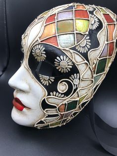 "Size: one size Traditional and original papier-mache Venetian mask, handmade and decorated with trimmings, stucco and acrylics. This traditional Venetian mask shape is called \"Volto mask\" and is a full face mask. This mask remembers Harlequin for the style of the decoration and its coloros. All our masks are handmade papier-machè masks, made in Venice. Our decorators use techniques typical of the Venetian tradition such as stucco, acrylics, gold and silver-leaf, macramè, passementerie, pearls Artistic Masquerade Mask For Mardi Gras, Artistic Masks And Prosthetics For Mardi Gras, Multicolor Full Face Carnival Mask, Artistic Masquerade Mask For Carnival, Handmade Artistic Masks For Carnival, Artistic Multicolor Masquerade Mask For Carnival, Artistic Multicolor Masquerade Mask For Mardi Gras, Artistic Multicolor Masks For Carnival, Artistic Multicolor Masquerade Masks