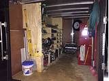 the inside of a garage with tools and other items on shelves, including an open door