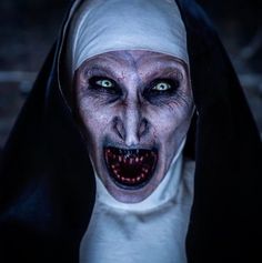 a creepy nun with green eyes and white makeup