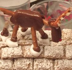 a toy horse made out of marshmallows on top of a brick wall