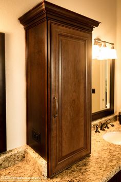 a wooden cabinet sitting on top of a bathroom counter