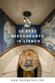 the inside of a restaurant with blue and white tiles on the walls, along with a round table