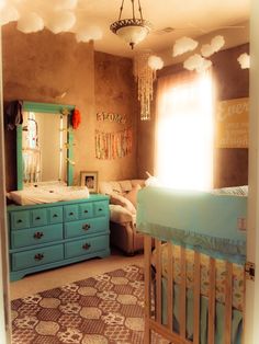 a baby's room with a crib and dresser