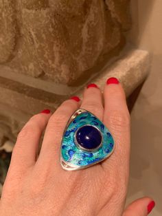 Handmade Cloisonne Enamel on Silver Ring with Natural Lapis Lazuli Stone Handmade by me and my 19 year old son in our beautiful Kansas City studio. See our work and follow us on Instagram please. Questions and comments are welcome. Get free shipping when you become our follower. Instagram: https://www.instagram.com/anaraandco/ Cloisonne is ancient art, that dates centuries back in history. Tiny silver wires were bent and twisted according the design. Then small sections were filled with colorful Blue Cabochon Fusion Jewelry, Artisan Blue Rings One Of A Kind, Artisan Blue Ring, Handmade Enamel Ring, Locket Ring, Lapis Lazuli Jewelry, Lapis Lazuli Stone, Cloisonne Enamel, Sterling Silver Cross