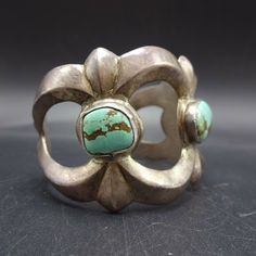 "VINTAGE NAVAJO BRACELET DESCRIPTION: Heavy gauge cast sterling silver, along with a trio of gorgeous light blue turquoise cabs, this bracelet will be a cherished addition to your collection of fine vintage Native American jewelry. MEASUREMENTS: Interior of the cuff measures 5 3/8\" with an additional 1 1/4\" non-adjustable gap. Total circumference: 6 5/8\" Measures 2 1/4\" straight across the widest part (from wrist bone to wrist bone) Bracelet face measures 1 3/4\" wide (the face of the bracel Vintage Sterling Silver Collectible Bangle, Silver Patina Jewelry For Weddings, Vintage Sterling Silver Nickel-free Bangle, Nickel Free Sterling Silver Vintage Bangle, Vintage Sterling Silver Cuff Bracelet For Anniversary, Vintage Adjustable Cuff Bracelet Stamped 925, Elegant Silver Patina Bracelets, Vintage Adjustable Stamped 925 Cuff Bracelet, Elegant Silver Bracelets With Patina