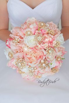 the bride's bouquet is made up of pink and white flowers with gold sequins