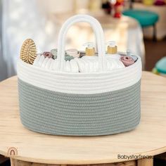 a white basket sitting on top of a wooden table