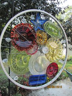 a circular glass window with many different colored objects in the center and on it's sides