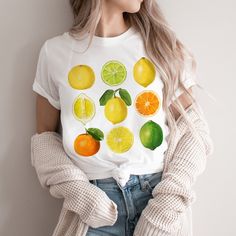 This cute cottagecore shirt features a variety of vintage citrus. This trendy design will your new favorite shirt that you reach for again and again. Makes a great gift for any lemon, lime and orange lover. * Q U I C K * F A C T S * ♥ Solid colors are 100% cotton ♥ Heather colors are cotton/poly blend ♥ Design is high quality digital print ♥ Wash and dry normally (on cool for best results) * S I Z I N G * ♥ Sizing is unisex so runs like men's, though not overly large ♥ Most women find their typi Cute White Tops With Fruit Design, Cute White Fruit Design Tops, Casual Yellow Tops With Fruit Print, Casual Orange Fruit Print Top, Casual Yellow Top With Fruit Print, Casual White Tops With Fruit Design, White Casual Top With Fruit Design, Casual White Top With Fruit Design, White Cotton Shirt With Fruit Print