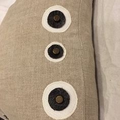 a close up of a pillow with buttons on the front and back of it's cover