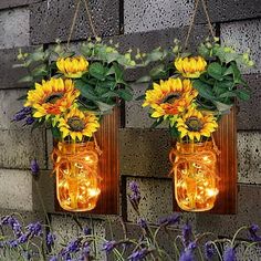 two mason jars with sunflowers hanging from them