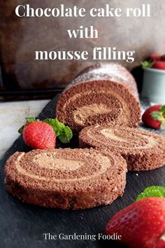 chocolate cake roll with mousse filling on a cutting board next to strawberries