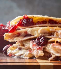 a stack of cranberry and chicken quesadillas on a cutting board