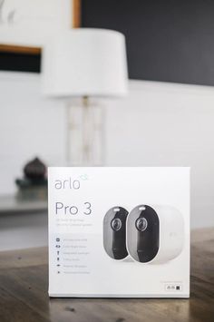 an arlo pro 3 wireless earbuds sitting on top of a table