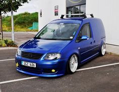 a blue van parked in front of a building