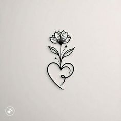 a heart shaped paper cutout with flowers on the side and a flower in the middle