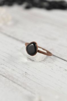 Your raw gemstone ring collection is not complete without a stacking, raw black obsidian ring. Handmade with healing crystals and natural stones, this copper jewelry awakens the wild woman. The raw black obsidian jewelry is made with electroformed copper, making each piece unique and one of a kind, just like you. Embrace your intuitive nature and click through to see more raw gemstone jewelry! Black Agate Round Ring, Minimalist Handmade Black Ring, Gift Black Agate Ring, Handmade Black Crystal Promise Ring, Black Gemstone Rings For Healing, Black Rings With Natural Stones For Gift, Hand Forged Black Rings, Minimalist Hand Forged Black Rings, Black Obsidian Jewelry