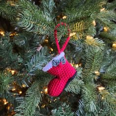 a crocheted ornament hanging from a christmas tree