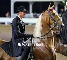 two men in suits and hats riding horses