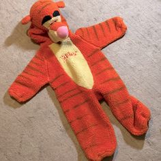 an orange stuffed animal laying on the floor