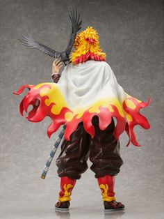 the action figure is dressed in red, yellow and white with a bird on his shoulder