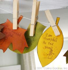 three autumn leaves hanging from clothes pins on a line with the words, i love you to the moon and back