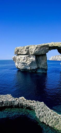 an arch in the middle of the ocean