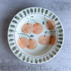 a plate with oranges painted on it