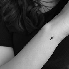 a person with a small tattoo on their arm