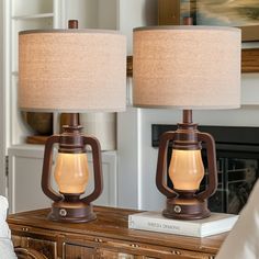 two lamps sitting on top of a wooden table