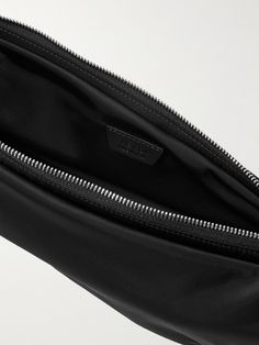 The Row's 'Caiden' messenger bag is sized to fit the daily essentials, like your phone, cardholder and keys. It's been made in Italy from durable shell and has a compact crescent shape. Luxury Rectangular Belt Bag With Zipper Pocket, Luxury Travel Mobile Phone Pouch, Modern Pouch With Cell Phone Pocket, Modern Black Pouch With Cell Phone Pocket, Designer Travel Bags With Cell Phone Pocket, Functional Business Belt Bag For Mobile Phone, Luxury Belt Bag With Cell Phone Pocket For Travel, Messenger Bag For Men, Crescent Shape