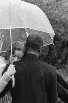 a couple embracing under an umbrella in the rain