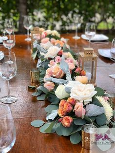 a long table with flowers and candles on it