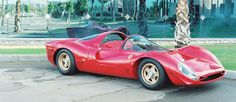 a red sports car parked in front of a building