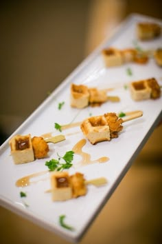 small appetizers are arranged on a white plate