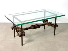 a glass and metal coffee table with wheels on it