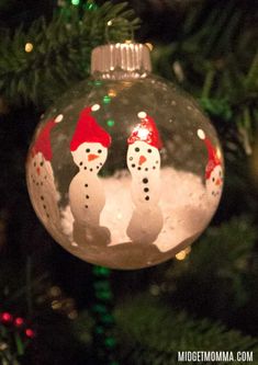 a christmas ornament with two snowmen on it